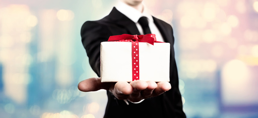 Businessman presenting a gift box